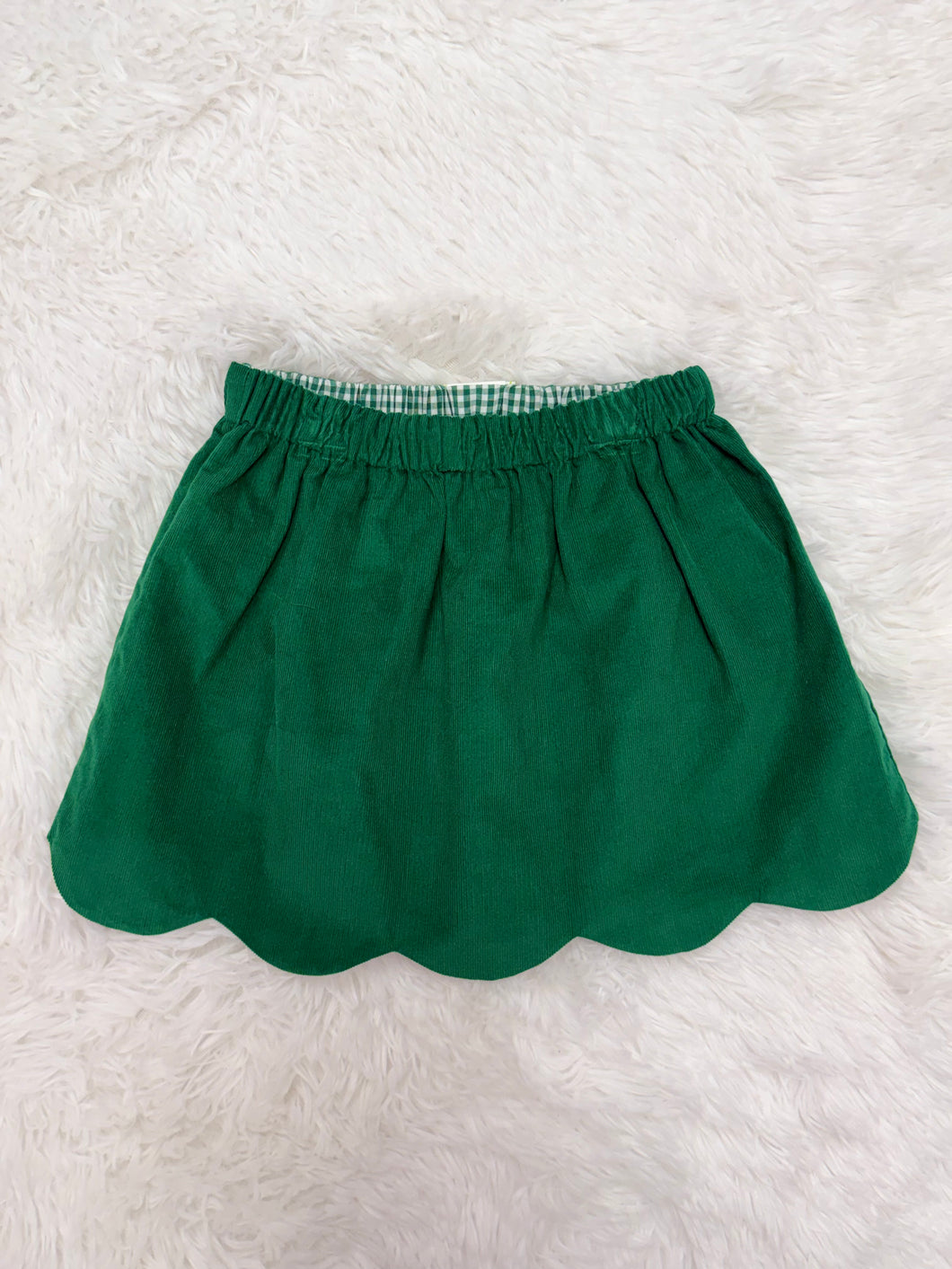 Celebrate the season in style with the Girls Kendall Christmas Tree Corduroy Skirt from Zuccini Kids. Crafted from soft, durable corduroy, this skirt offers both comfort and festive charm. Its adorable Christmas tree design adds a playful holiday touch perfect for family gatherings or seasonal parties. Pair with the coordinating Scalloped Collar Blouse.