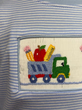 Load image into Gallery viewer, Embroidered patch on a blue and white striped fabric with a green truck and colorful items.
