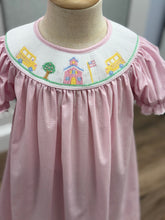 Load image into Gallery viewer, Step into the school year with charm in the Girls School House Bishop Dress by Petit Bebe. Its delicate pink check gingham and intricate school house smocking bring timeless elegance to the first day of school—making every moment feel special and unforgettable!
