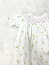 Load image into Gallery viewer, Dress your little princess in the Infant Girls Zoe Hand Smocked Bishop Bubble from Baby Loren. Crafted from soft Pima cotton, this charming bubble features delightful purple smocking and a sweet pink and purple tulip pattern. It's perfect for creating joyful memories while ensuring comfort and style!
