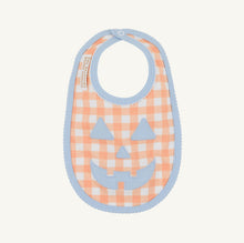 Load image into Gallery viewer, The Beaufort Bonnet Company’s Burp Me Bib in Seashore Sherbet Gingham &amp; Beale Street Blue is the sweetest fall baby essential, with a Jack-O-Lantern face on the front, picot and trim along the outer edge, and a snap closure. Pretty and practical meet in the most festive way!
