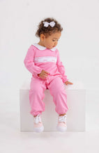 Load image into Gallery viewer, The Rigsby Romper in Hamptons Hot Pink by The Beaufort Bonnet Company brings vibrant charm to your little girl’s wardrobe. Its soft, classic design is enhanced by a delicate white Peter Pan collar with pink trim and sweet bow smocking, making every moment irresistibly adorable and joyful!
