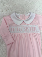 Load image into Gallery viewer, Introduce your little one to timeless elegance with this charming Little Sister Smocked Footie from Magnolia Baby. Crafted with meticulous attention to detail, the delicate smocking adds a touch of sophistication to everyday wear. The soft, breathable fabric keeps your baby comfortable throughout the day and night, while the convenient footie design means easy diaper changes and secure warmth. 
