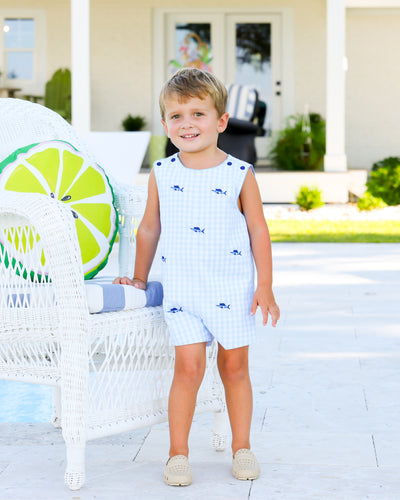 Dress up your little one in our Blue Marlin Scalloped Jon Jon by Cape Point Clothing Co. This adorable jon jon features a fun blue check pattern and intricate blue marlin fish embroidery. Complete the look with the sister bloomer set!