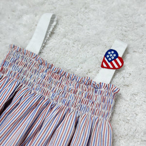 Celebrate your little one's love for the stars and stripes with our Infant Girls 4th of July Patriotic Donna Romper! Made from seersucker fabric in patriotic red, white, and blue, this romper features a smocked bodice and adorable heart US flag embellishment. Perfect for showing off her American pride!