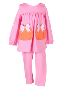 Dress your little one in festive charm with the Pumpkins Tabby Tunic and Legging Set from The Yellow Lamb. This bright pink outfit features playful pumpkin appliques as pockets and delicate bow accents, perfect for celebrating fall and Halloween in style. Comfortable and cute, it’s ideal for keeping her cozy and picture-ready at every seasonal event.