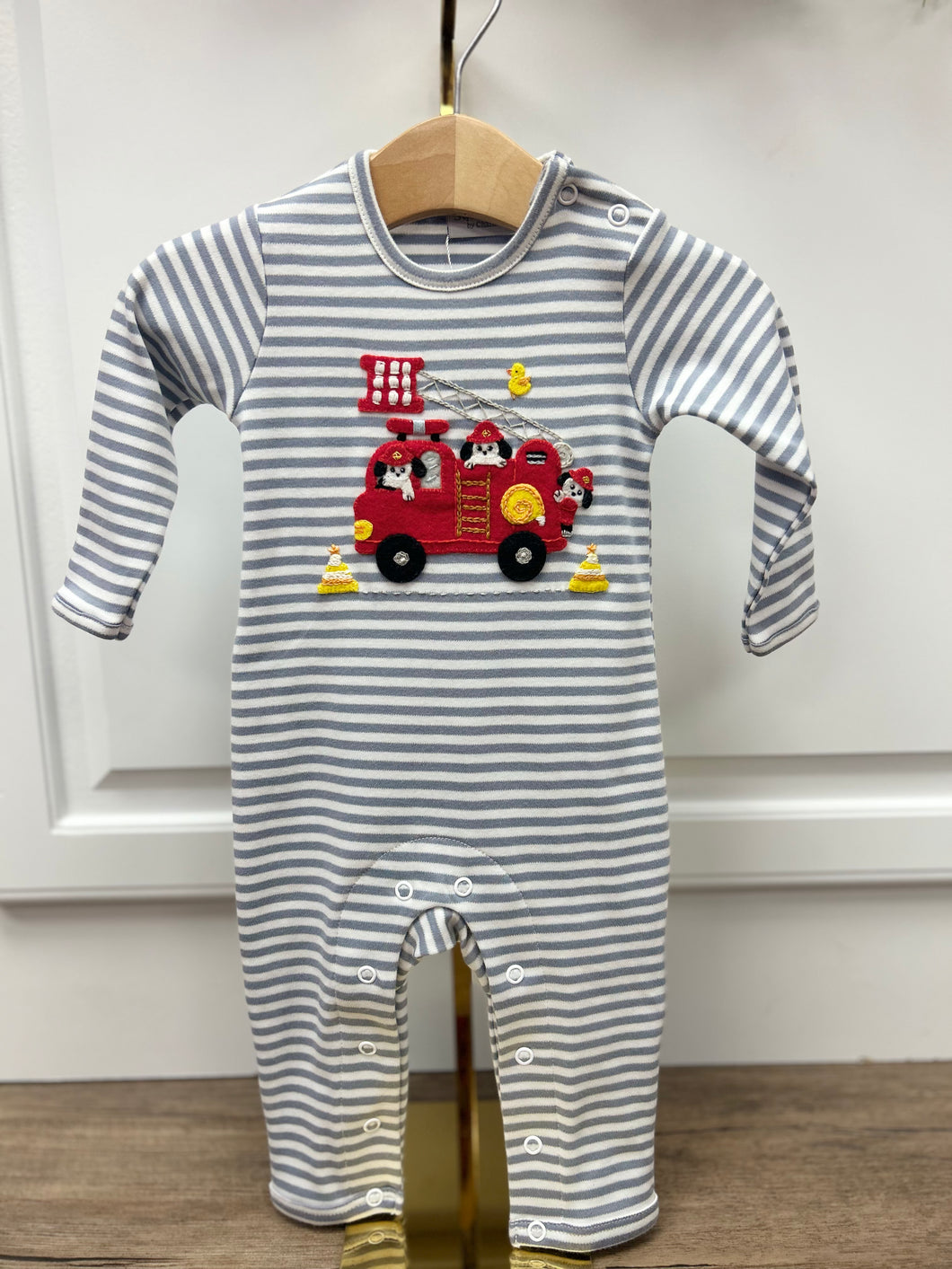 Get your little one ready to save the day with our Infant Boys Striped Puppy Rescue Romper! This adorable romper from Squiggles features gray stripes and a cute appliqué of a fire truck with puppies coming to the rescue. Perfect for a future hero!