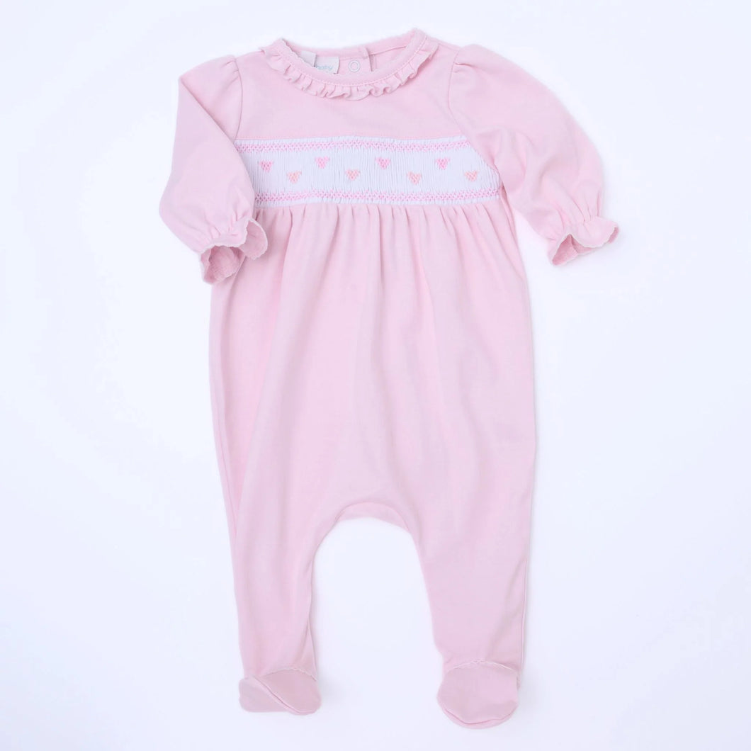 Celebrate love with our Valentine’s Classic Smocked Footie by Magnolia Baby! Made with soft pink Pima cotton and adorned with smocked hearts, this footie is both adorable and comfortable. Perfect for your little one to wear on Valentine’s Day or any day to spread some love and joy.