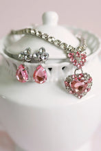 Load image into Gallery viewer, Classic glamour gets a modern twist with The Marilyn 4 Piece set. This bold and beautiful boxed-set includes pink &amp; silver clip-on earrings, a heart-shaped ring, and a coordinating necklace jam-packed with jewels.

- Keep away from fire and Small Parts.

- Batteries not required.

- Recommended Age: 3+
