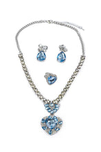 Load image into Gallery viewer, Classic glamour gets a modern twist with The Marilyn 4 Piece set. This bold and beautiful boxed-set includes blue &amp; silver clip-on earrings, a heart-shaped ring, and a coordinating necklace jam-packed with jewels.

- Keep away from fire and Small Parts.

- Batteries not required.

- Recommended Age: 3+
