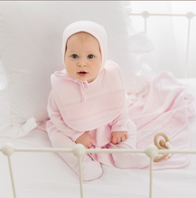 Load image into Gallery viewer, The Baby Smocked Bullion Bib by Feltman Brothers is a timeless accessory for your little one! This adorable baby bib matches perfectly with our Infant Smocked Bullion Gown and Hat and would be a perfect gift set! Perfect as a baby gift for your loved one, or as an heirloom piece to treasure forever! 

We carry the White/Blue and the White/Pink. The double pink bib in the lifestyle picture is not a color we carry, just a glimpse of this precious piece! 
