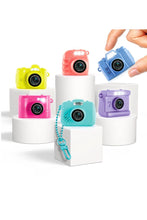 Load image into Gallery viewer, The Photo Creator Mini Camera gives kids a real photo and video experience in a tiny, easy-to-use design made just for them. Small enough to clip onto a backpack, this kid-friendly camera lets young creators capture everyday moments while exploring creativity on the go. It feels like real tech, but plays like a toy.
