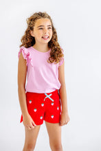 Load image into Gallery viewer, Elevate your little one’s wardrobe with the Ruehling Ruffle Top in Pier Party Pink! This delightful pink knit tee combines a classic silhouette with charming ruffles, perfect for creating fun, stylish outfits. Pair it effortlessly with Berry Sweet Shelby Anne Shorts for a look that radiates joy and confidence!

