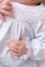 Load image into Gallery viewer, Welcome your newest blessing in The Beaufort Bonnet Company’s Sweetly Smocked Greeting Gown in Worth Avenue White with Palm Beach Pink, featuring smocked details and delicate sleeve accents that make every moment magical. This convertible gown offers the convenience of an elastic bottom for easy diaper changes while keeping baby cozy and comfortable. Ideal for those precious first days at home, hospital photos or gifting to expecting parents.
