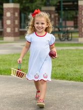 Load image into Gallery viewer, Celebrate your little one’s milestones in the Apple Trio Dress by Trotter Street Kids. This breathable blue gingham dress, adorned with charming apple appliqués, brings joyful comfort and sweet style to her first day of school. Ready to inspire smiles and confidence every step of the way!
