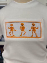 Load image into Gallery viewer, Ignite your little one’s Halloween spirit with the Spunky Skeletons Boys Short Set by Cape Point Clothing Co.! The lively skeleton smocking on a crisp white tee pairs brilliantly with vibrant orange shorts—comfort and festive fun combined for spirited toddler adventures!

 
