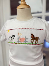 Load image into Gallery viewer, Petit Ami’s Farm Smocked Short Set brings autumn to life with a soft white tee featuring charming farm animal smocking and vibrant red gingham shorts. This joyful ensemble captures the warmth and spirit of harvest season, making every moment outdoors feel magical and bright!

 
