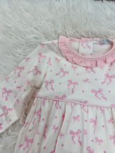 Load image into Gallery viewer, Celebrate your baby girl’s charm with the Pink Coquettes Pima Romper by Baby Loren. Crafted from soft Pima cotton, its delicate pink ruffle collar and bow print create an irresistibly sweet look, while the pink piping adds a timeless touch of elegance.

 
