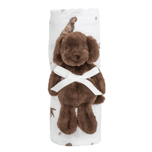 Load image into Gallery viewer, Mud Pie’s Lab Swaddle and Rattle Set is a delightful 2-piece collection designed to provide comfort and joy for your little one. The muslin swaddle blanket, measuring 47" x 47", is crafted from 100% cotton, ensuring a soft and breathable wrap for your baby. It comes beautifully rolled with a coordinating faux fur plush rattle, shaped like an adorable dog, measuring 8" in size. This charming set is perfect for snuggling, soothing, and playtime, making it an ideal gift for new parents!
