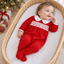 Load image into Gallery viewer, Wrap baby in the warmth and wonder of the season with the Millie Smocked Footie, a timeless piece made for holiday magic by Magnolia Baby. Dressed in a rich, festive red, this one-piece captures the spirit of Christmas with its delicate hand-smocked detailing and embroidered rosebuds, creating a look that feels both classic and heirloom-worthy.

