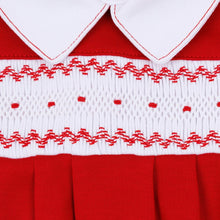 Load image into Gallery viewer, A timeless essential with a festive touch, the Miles Smocked Footie by Magnolia Baby blends classic style with everyday comfort. Crafted in a rich red hue, it features an elegant hand-smocked panel with delicate contrast embroidery and a crisp white Peter Pan collar for a polished, traditional look.
