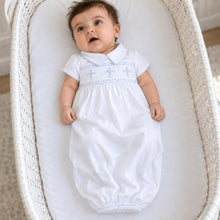 Load image into Gallery viewer, Elegant and meaningful, the Forever Blessed Smocked Gown is a beautiful choice for celebrating your baby’s most special moments. Designed with a classic hand-smocked panel across the chest, it features delicate light blue embroidered crosses for a soft, faith-inspired touch.
