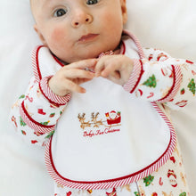 Load image into Gallery viewer, Make baby’s first holiday season even more special with the&nbsp;Magnolia Baby Christmas Magic Baby’s First Christmas Bib. Featuring a charming hand-embroidered “Baby’s First Christmas” design, this bib is both a practical essential and a treasured keepsake.
