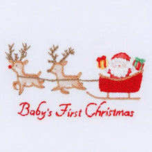 Load image into Gallery viewer, Make baby’s first holiday season even more special with the&nbsp;Magnolia Baby Christmas Magic Baby’s First Christmas Bib. Featuring a charming hand-embroidered “Baby’s First Christmas” design, this bib is both a practical essential and a treasured keepsake.

