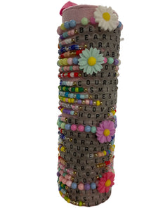 Show your confidence with these Swiftie inspired friendship bracelets! Each one features inspiring words and fun glow in the dark beads for extra fun. Plus, with proceeds going to charity, you can make a positive impact while expressing yourself. Made by Anuja Tolia.