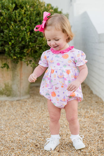 The Tricks & Treats Keeley Bubble from James & Lottie brings festive fun to any Halloween celebration. Its charming pink fabric showcases a playful Halloween print, while the sweet ruffle neckline adds a delightful touch. Designed for comfort and movement, this bubble lets girls enjoy playtime and festivities with ease and style. Perfect for making Halloween memories extra special.