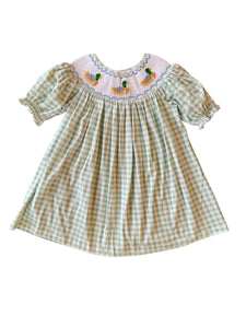 Dress your little one in timeless charm with the Smocked Bishop Kate Mallard Dress by Shop Teeta. Featuring a classic green and white gingham check, this dress is adorned with delicate smocking at the neckline and detailed embroidered mallard ducks, adding a sweet and playful touch. Perfect for coordinated family moments, it also pairs beautifully with matching sibling styles. This piece combines traditional design with exceptional craftsmanship, making it an irresistible choice for any special occasion or 