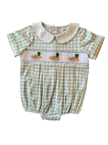 Dress your little one in timeless charm with the Boys Smocked Noah Mallard Bubble by Shop Teeta. Featuring a classic green and white gingham check, this bubble is adorned with delicate smocking and detailed embroidered mallard ducks, adding a sweet and playful touch. Perfect for coordinated family moments, it also pairs beautifully with matching sibling styles. This piece combines traditional design with exceptional craftsmanship, making it an irresistible choice for any special occasion or everyday delight