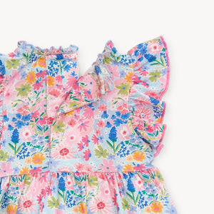 Experience the beauty of spring in our Lily Vibrant Floral Dress from Magnetic Me. Featuring a stunning floral pattern, cute puffy sleeves, and a charming tiered skirt, this dress is perfect for your little one. Plus, smaller sizes come with a convenient diaper cover.