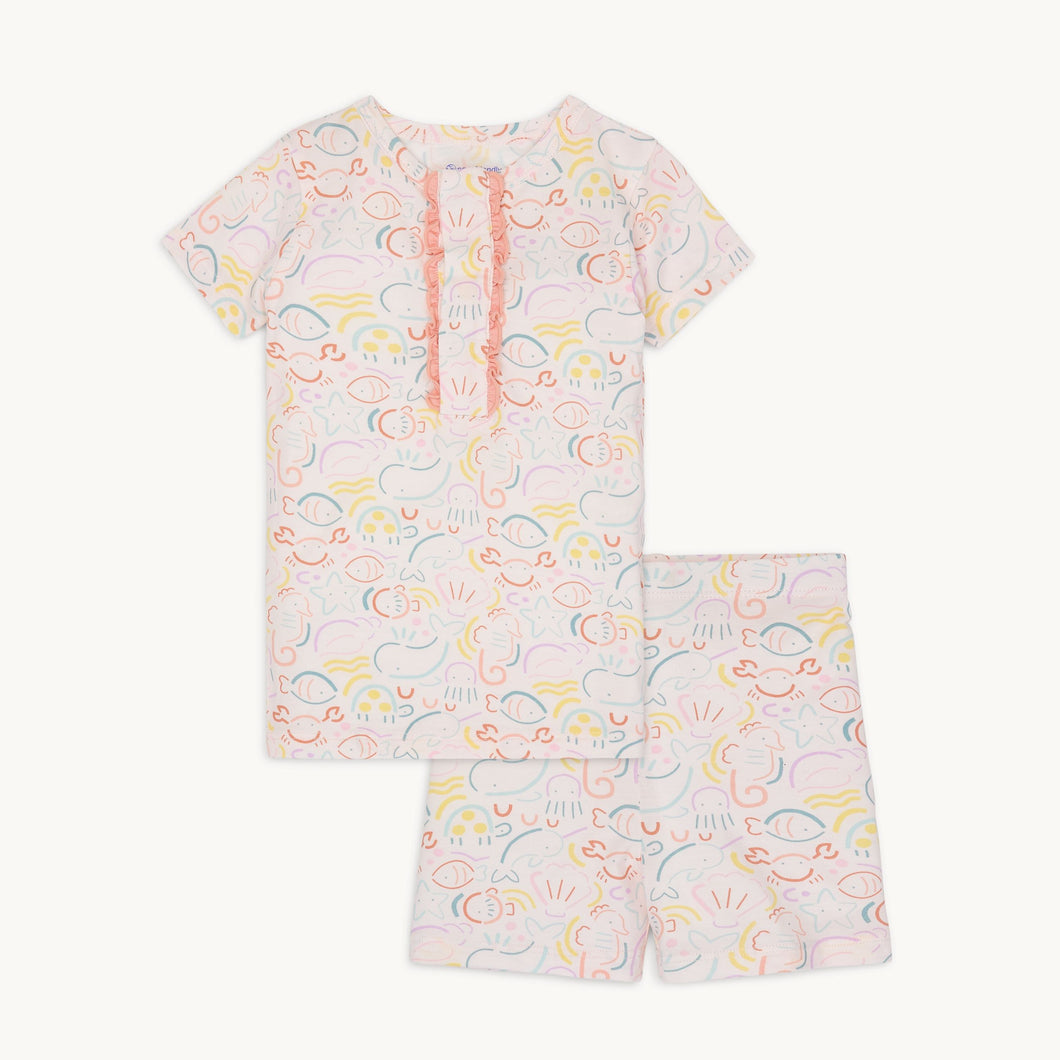 Experience the magic of the sea with our So Fish-Ticated Short Sleeve Ruffle Pajama Set from Magnetic Me! Featuring a charming under the sea design in soft, pastel colors, this set is perfect for toddler girls. The top includes magnetic closures and delicate ruffle details for added convenience and cuteness!