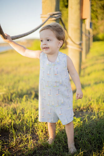 Introducing the Toddler Boys Mariner Jon Jon from The Proper Peony! Made with 100% Pima cotton, this adorable jon jon features a charming mariner motif in light blues and sailboat design. Perfect for your little one's coastal adventures. Order now and make a stylish statement!