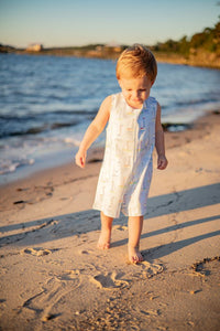 Introducing the Toddler Boys Mariner Jon Jon from The Proper Peony! Made with 100% Pima cotton, this adorable jon jon features a charming mariner motif in light blues and sailboat design. Perfect for your little one's coastal adventures. Order now and make a stylish statement!