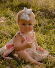 Load image into Gallery viewer, The Etta Sunsuit from The Yellow Lamb is the perfect choice for spring! Featuring a beautiful floral palm print, this outfit will keep your little girl stylish and comfortable. The elegant ties on each side add a special touch, and the included matching diaper cover makes dressing easy.

