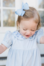 Load image into Gallery viewer, The Ava Blue Floral Payton Long Bubble from James &amp; Lottie features a charming floral print collar that adds a touch of sweetness to her wardrobe. Designed with short sleeves and delicate details, this long bubble offers both comfort and style, making it perfect for any occasion this season. Dress her in this delightful piece to keep her looking effortlessly fashionable and comfortable all day long.
