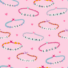 Load image into Gallery viewer, Get ready for stylish comfort with our Friendship Bracelet Pima Button Up Lounge Set! Designed for girls, this set includes a hot pink knit lounge shirt and matching shorts featuring every girl&#39;s favorite friendship bracelet design. Perfect for lounging or playing, from James &amp; Lottie.
