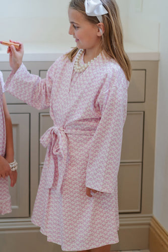 Elevate your little girl's relaxation time with the Gwen Girls' Spa Wrap in Pretty Pink Bows by Lila & Hayes. Designed for comfort and style, this wrap offers a cozy, spa-like experience at home. Pair it with the Pretty Pink Bows Lounge Dress and Doll Dress to create an irresistible gift set that brings joy and matching charm for both girl and doll. Perfect for playtime or unwinding, this spa wrap is a delightful addition to any child's wardrobe.