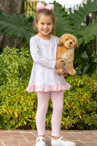 Dress your little one in the adorable Puppy Pals Ruffle Pants Set from Trotter Street Kids. Featuring charming puppy and dog house prints paired with soft pink leggings, this set combines playful style with comfortable wear. Perfect for everyday adventures, it keeps your child cozy while adding a touch of fun to their wardrobe.