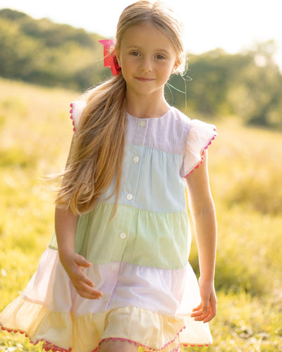 Get your little one ready for Spring with our adorable Seersucker Remy Rainbow Dress! Made with a seersucker color block design and cute ric rac details, this set is perfect for toddler girls. And with a matching Infant dress set available for little sisters, they can have a stylish sibling match!