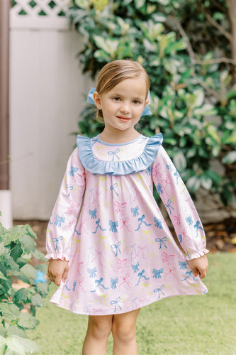 Dress your little one in the Ribbon Party Long Sleeve Dress from The Proper Peony, designed for both comfort and charm. Its soft knit fabric ensures ease of movement and cozy wear, while the playful bow pattern and ruffle bib collar add a sweet, elegant touch. Perfect for special occasions or everyday fun, this pink dress combines style and softness to keep your toddler happy and looking adorable.