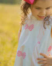 Load image into Gallery viewer, Dress your infant girl in the adorable Ada Ribbons &amp; Bows Dress from The Yellow Lamb. This charming dress features a pink bow and ribbon design and beautiful ruffle neckline detail. Don&#39;t forget to grab the matching Ada Ribbons &amp; Bows Bubble for a sibling set!
