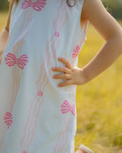 Load image into Gallery viewer, Dress your infant girl in the adorable Ada Ribbons &amp; Bows Dress from The Yellow Lamb. This charming dress features a pink bow and ribbon design and beautiful ruffle neckline detail. Don&#39;t forget to grab the matching Ada Ribbons &amp; Bows Bubble for a sibling set!
