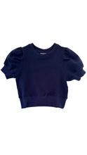 Load image into Gallery viewer, Elevate any outfit with our Riley Sweatshirt in Navy. This short sleeve, ruffle shoulder sweatshirt for tween girls is perfect for pairing with jeans or a skirt. Complete the look with our Scottie Spots Skirt from pleat.
