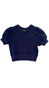 Elevate any outfit with our Riley Sweatshirt in Navy. This short sleeve, ruffle shoulder sweatshirt for tween girls is perfect for pairing with jeans or a skirt. Complete the look with our Scottie Spots Skirt from pleat.