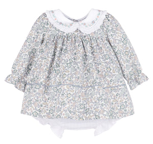 Dress your little one in the charming Bouncy Blooms Float Dress from Sophie &amp; Lucas. This delicate floral dress features an embroidered Peter Pan collar with ruffles, adding a sweet touch to every twirl. The coordinating bloomers provide comfort and ease for infants to toddler girls. Perfect for fall outings, its soft, breathable fabric and enchanting floral print make it a delightful choice for special moments and everyday wear.