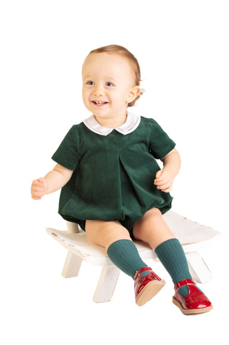 Elevate your little boy's festive wardrobe with the Boys Holly Jolly Velvet Bubble from Sophie & Lucas. Crafted from rich dark green velvet, this bubble features a charming white peter pan collar that adds timeless elegance. Perfect for holiday gatherings, it pairs beautifully with the Girl's Holly Jolly Velvet Miller Dress for coordinated family photos. Soft, stylish, and comfortable, this bubble is sure to make him the center of attention this season.