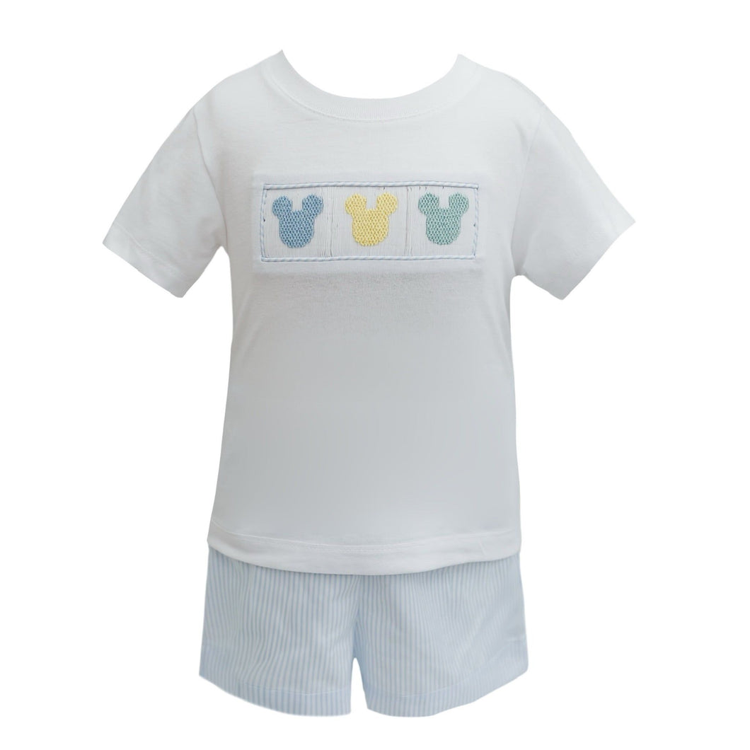 Get ready for your next Disney trip in style with our Smocked Mickey Stripe Short Set from Krewe Kids! This set includes a white tee with an adorable smocked detail featuring Mickey silhouettes embroidered on the front. Paired with coordinating blue and white striped shorts, you'll be both comfortable and fashionable for your magical adventure.